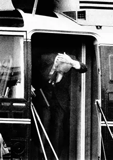 Clumsy: President Ford bumps his head after waving ?
