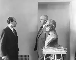 Rs6wnlcgr: President Harry Truman poses next to the bust