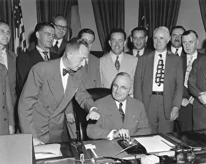Activating: President Harry Truman about to push a button