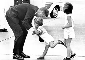 Squaw: President John Kennedy is greeted by his ?