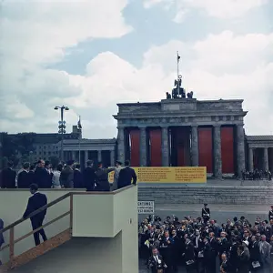 Justifying: President John Kennedy, on a platform overlooking