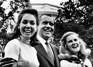 Tricia: President Nixon poses with his two daughters, ?