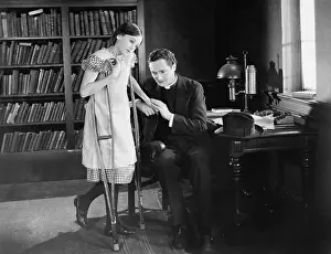 Supportive: Priest with girl on crutches