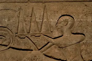 Xixth: Priest wearing offerings in a tray. Relief. Luxor temple. Eg