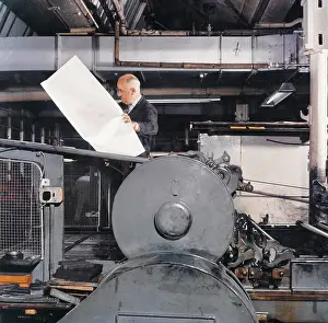 Proof: A printer checking a large proof