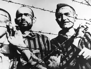 Inhuman: Prisoners behind barbed wire in a concentration camp, WW2