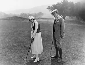 Knickerbockers: Profile of a couple playing golf in a golf course