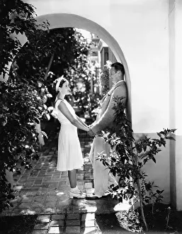 Arching: Profile of a couple romancing in an archway