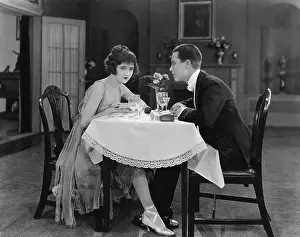 Frustration: Profile of a couple sitting at a table