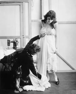 Adjust: Profile of a female tailor taking measurement of