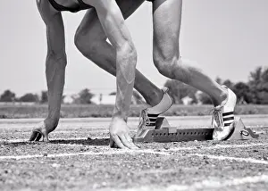 Sprinting: Profile Man Athlete Track Runner in Starting Block