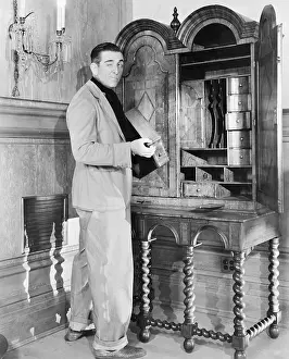 Wink: Profile of a man holding a drawer and winking