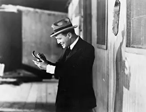 Fedora: Profile of a man looking happy and holding a horseshoe