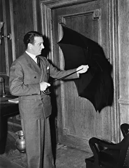 Safeguard: Profile of a man opening an umbrella