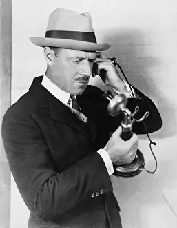 Fedora: Profile of a man talking on the telephone