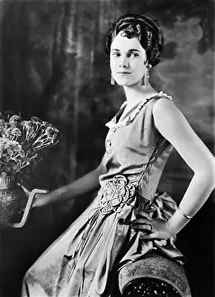 Poise: Profile of a woman holding a vase
