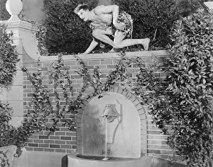 20 25: Profile of a young man crouching on a wall