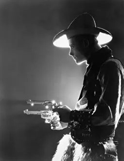 Sturdy: Profile of a young man holding guns