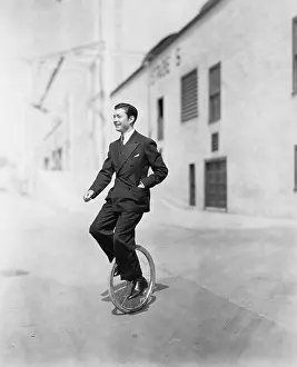 Uncommon: Profile of a young man riding a unicycle