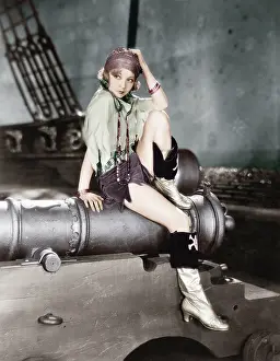 Ponder: Profile of a young woman sitting on a cannon and thinking
