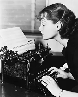 Employ: Profile of a young woman typing musical notes with