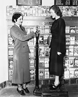 Consumerism: Profile of a young woman in an uniform measuring