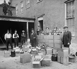 Bsloc1608: Prohibition agents stand with boxes and bottles