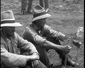 Prospecting: Two Prospectors Sitting in a Field Holding