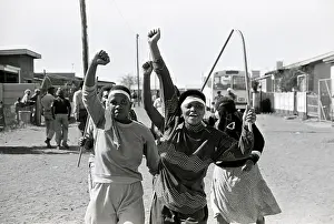Amandla: Protesters with clenched fists and cultural weapons