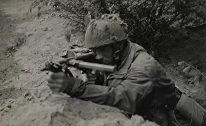 Relating: Pte J Connington of Selby, Yorks, in action with Sten gun