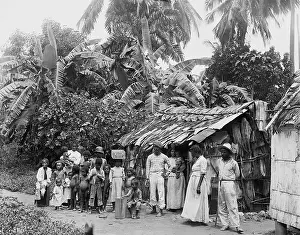 Shoeless: Puerto Ricans in front of a primitive dwelling ?