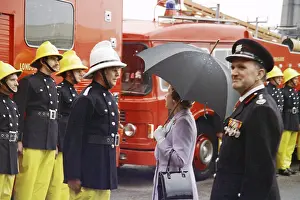 Waterproofs: Queen Elizabeth II inspecting firefighters