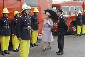 Waterproofs: Queen Elizabeth II inspecting firefighters