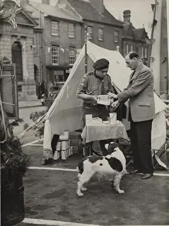 Queen's Scout selling Coronation programme