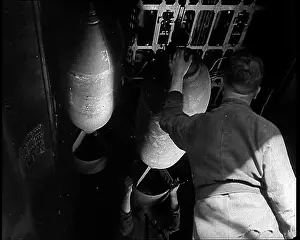 Fixing: An RAF Ground Crew Member Fixing Bombs to an
