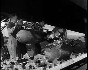 Fixing: RAF Ground Crew Members Fixing Bombs to an