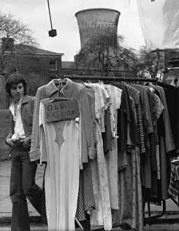 Cardboard: Rail of second-hand clothing in a street