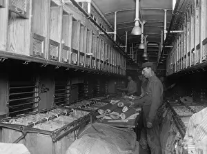 One Person: Railway Post Office (RPO) clerks sorting mail aboard