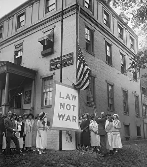 Anti War: Raising the LAW NOT WAR banner over the HQ of the