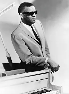 Definitive: Ray Charles, jazz performer, standing by a piano