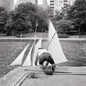 Rewarding: Rear View Anonymous Boy Putting Toy Sailboat Into