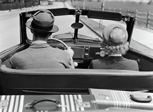 Convertibles: Rear view couple driving together in convertible