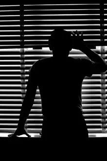 Ger002: Rear view silhouette of anonymous man peeking