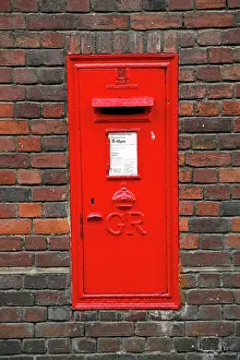Letterbox: Red English Post Box in a brick wall