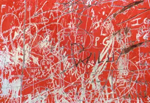 Scratch: Red painted wall scratched with graffiti