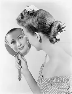 Sophisticate: Reflection of a young woman, looking in a mirror