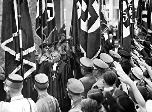 Consecrates: Reich Bishop Ludwig Mueller consecrates SA flags, 1934