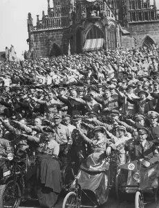 Enthusiastic: Reich Bishop Ludwig Muller among the cheering spectators in