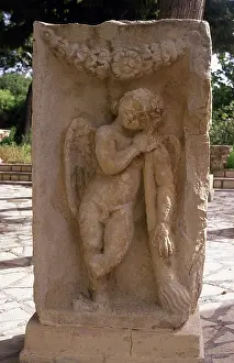 Cupid: Relief of Cupid with torch burning passion. Roman Art. Makta