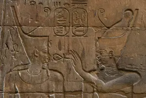 Mithological: Relief depicting Egyptian divinity giving the Ankh to a phar